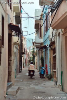 Man on scooter vanishes down a side street in Rethymno. Rethymno, Greece. © 2002 Photographicon