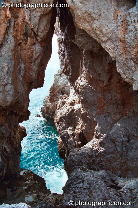 The sea swelling though a rocky cove at Agios Pavlos. Agios Pavlos, Greece. © 2002 Photographicon