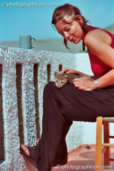 Ingrid strokes a wild kitten at Agios Pavlos. Agios Pavlos, Greece. © 2002 Photographicon