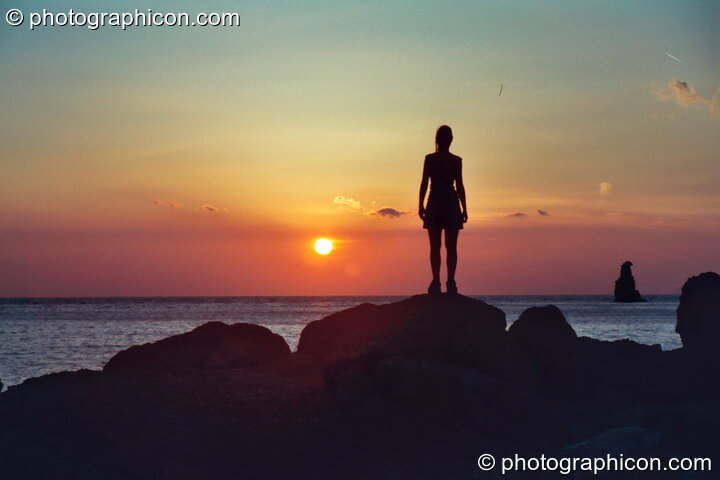 Woman looks out to sea, silhouetted by the golden sunset at Agios Pavlos. Agios Pavlos, Greece. © 2002 Photographicon