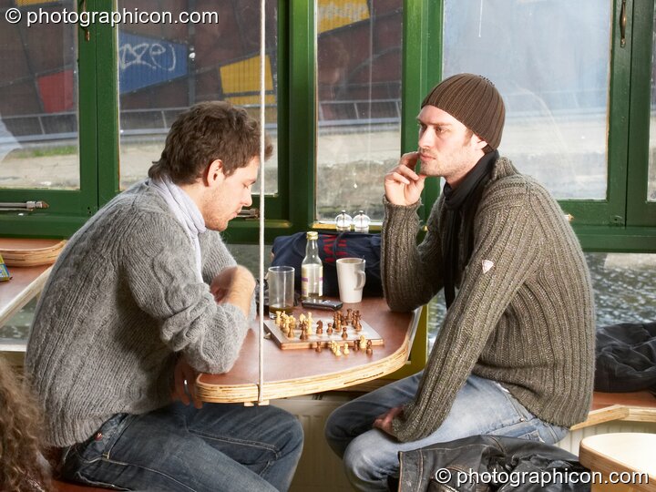 Two men play chess at a table in the inSpiral Lounge organic cafe and multimedia venue. London, United Kingdom. © 2008 Photographicon