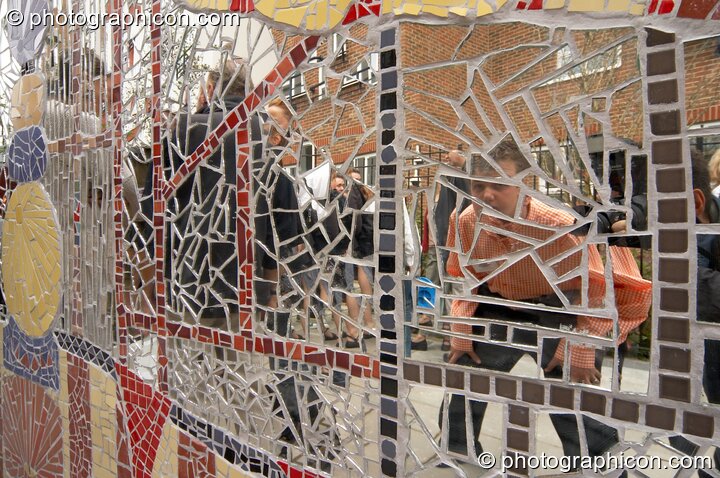 People reflected in the mirror tiles of the Save The World Club's Hundertwasser mosaic. Kingston Upon Thames, United Kingdom. © 2005 Photographicon